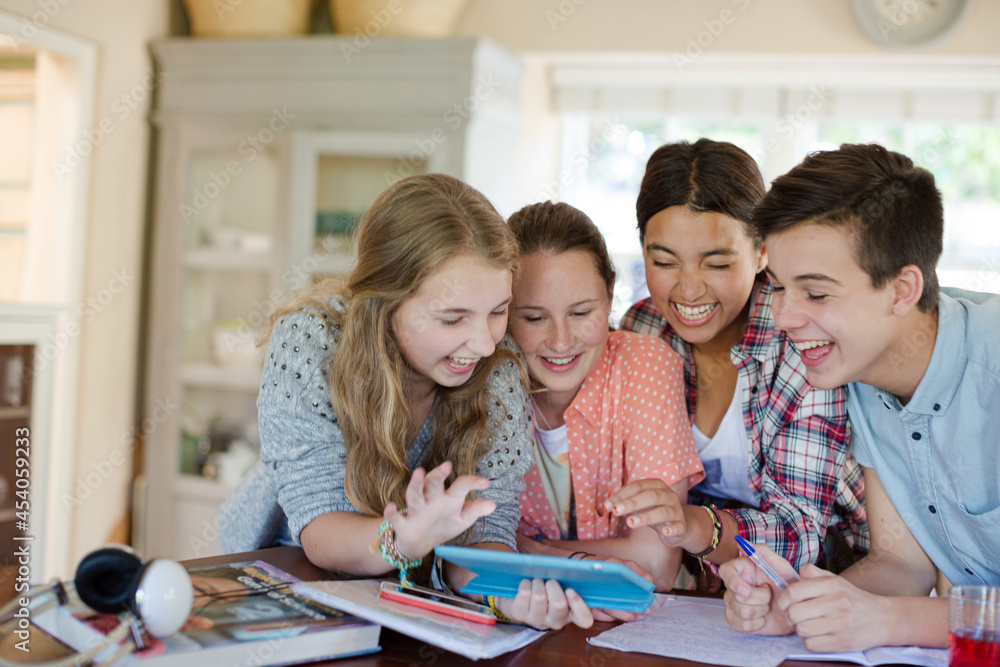 Group of smiling teenagers taking selfie in dining room Group of smiling teenagers taking selfie in dining room