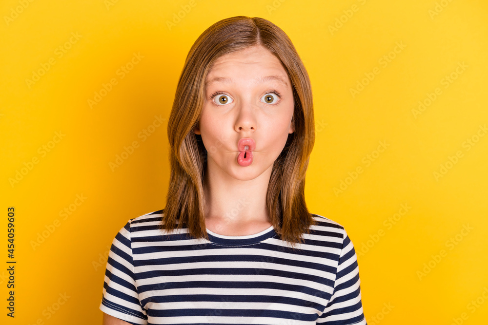 Portrait of carefree positive pupil lips make fish face have fun look camera isolated on yellow color background Portrait of carefree positive pupil lips make fish face have fun look camera isolated on yellow color background