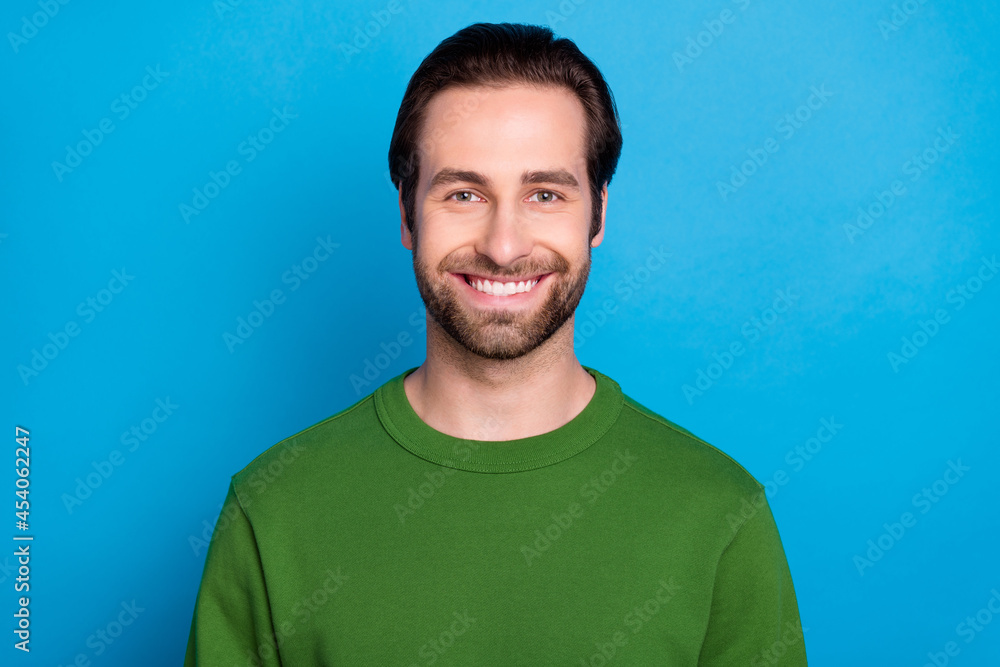 Portrait of positive cheerful person smile kind face look camera have good mood isolated on blue color background Portrait of positive cheerful person smile kind face look camera have good mood isolated on blue color background