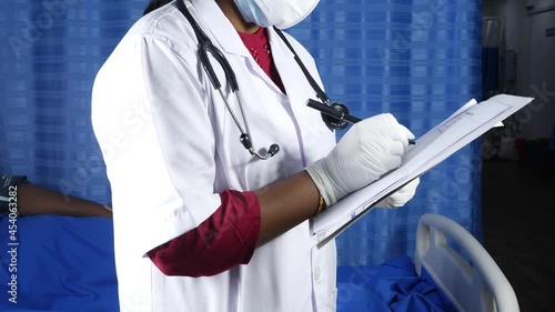 View of doctor writing prescription for patient, Doctor holding pen and pad