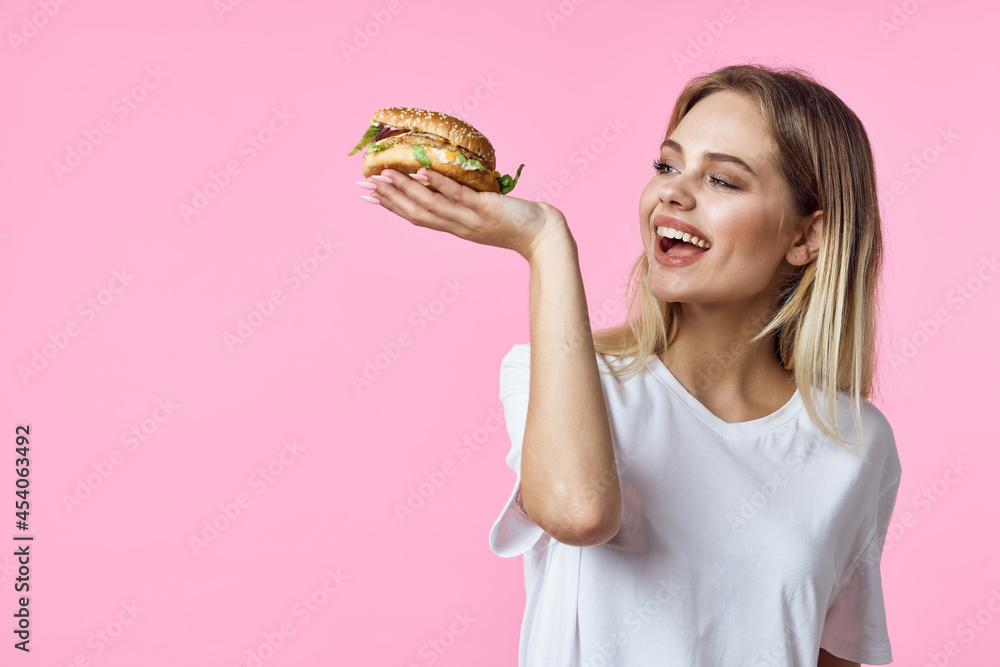 cute blonde in white t-shirt hamburger delicious food restaurant cute blonde in white t-shirt hamburger delicious food restaurant