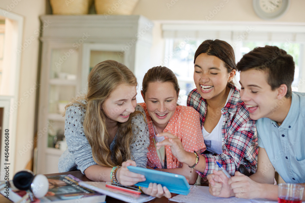 Group of smiling teenagers taking selfie in dining room Group of smiling teenagers taking selfie in dining room