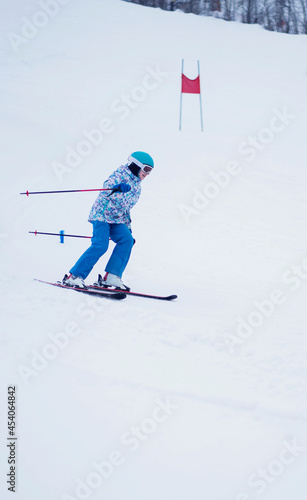 Children's sports. Girl skiing from the mountain. Amateur sports