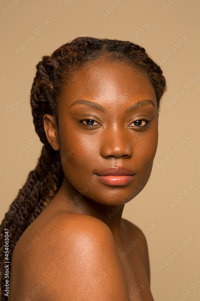 Studio portrait of shirtless woman with braided hair Studio portrait of shirtless woman with braided hair