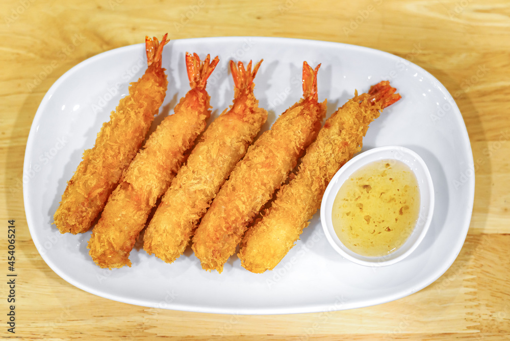 Deep-fried shrimp with sweet sauce on white plate
