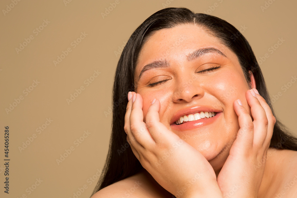 Studio portrait of smiling young woman with eyes closed Studio portrait of smiling young woman with eyes closed