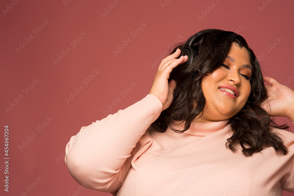 Studio shot of smiling woman with headphones Studio shot of smiling woman with headphones