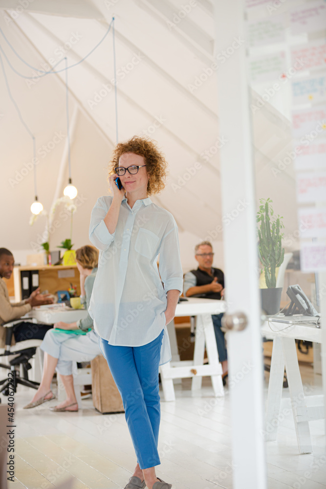 Portrait of woman talking on phone at office Portrait of woman talking on phone at office