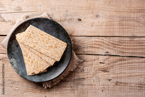 Traditional matzah bread on rustic wooden table.Copy space photo