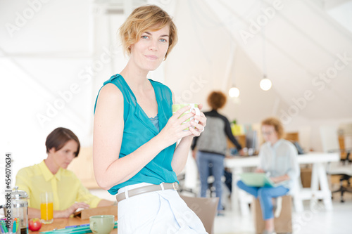Young smiling woman sitting at desk