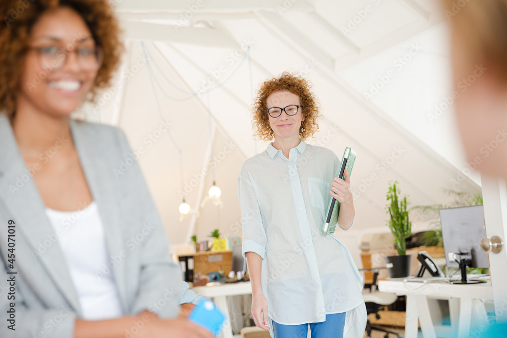 Woman walking and carrying laptop, joining colleague from office Woman walking and carrying laptop, joining colleague from office