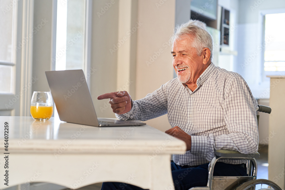 Senior has fun on laptop computer while making video call Senior has fun on laptop computer while making video call