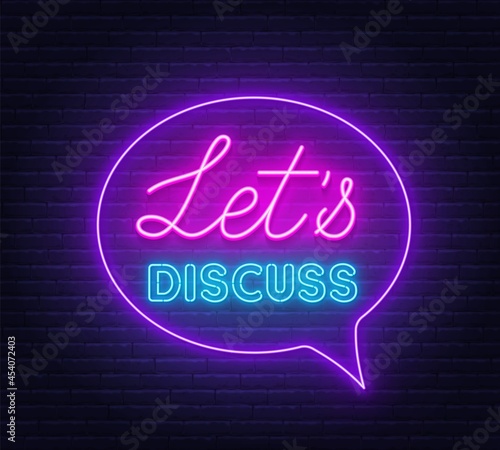 Neon sign Let s Discuss in the speech bubble on brick wall background.