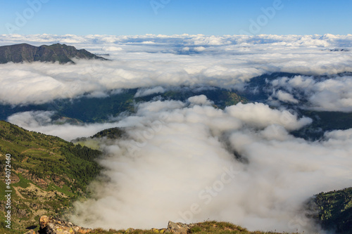 Panoramic sea of white clouds with mountains
