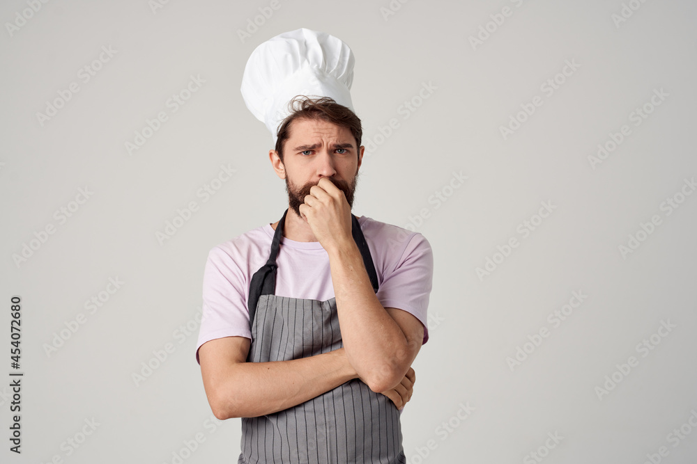 bearded man in apron working as a cook Professional bearded man in apron working as a cook Professional