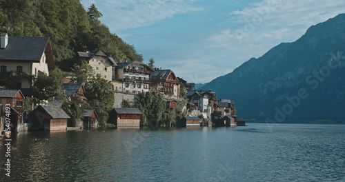 Breathtaking view of stunning beautiful nature and vallage on coastline. Inspiring landscape of high mountains with trees, clear blue water on magnifficent sunny day. Concept of freedom, travel. photo