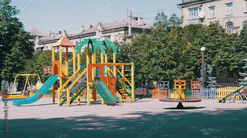 Wallpaper Mural Rotation of an Empty Multicolored Carousel on a Playground in a City Park. Deserted park in summertime. People, children stay at home on self-isolation. Pandemic, quarantine, infection, covid-19. 4K. Torontodigital.ca