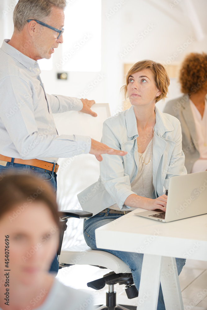Fototapeta premium Office workers talking at desk