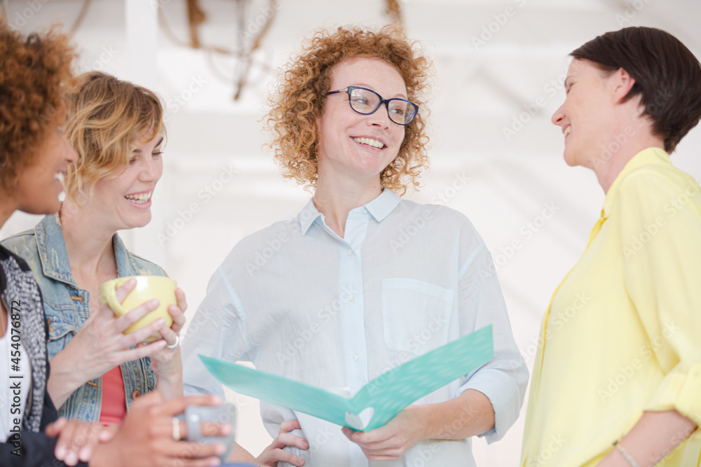 Fototapeta premium Portrait of female colleagues smiling in office