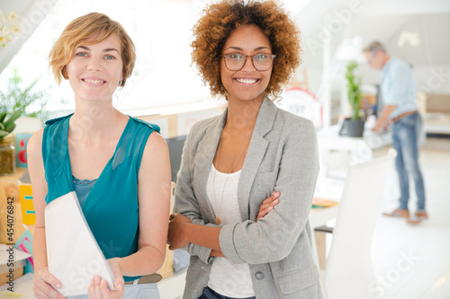 Women  smiling in office  holding documents