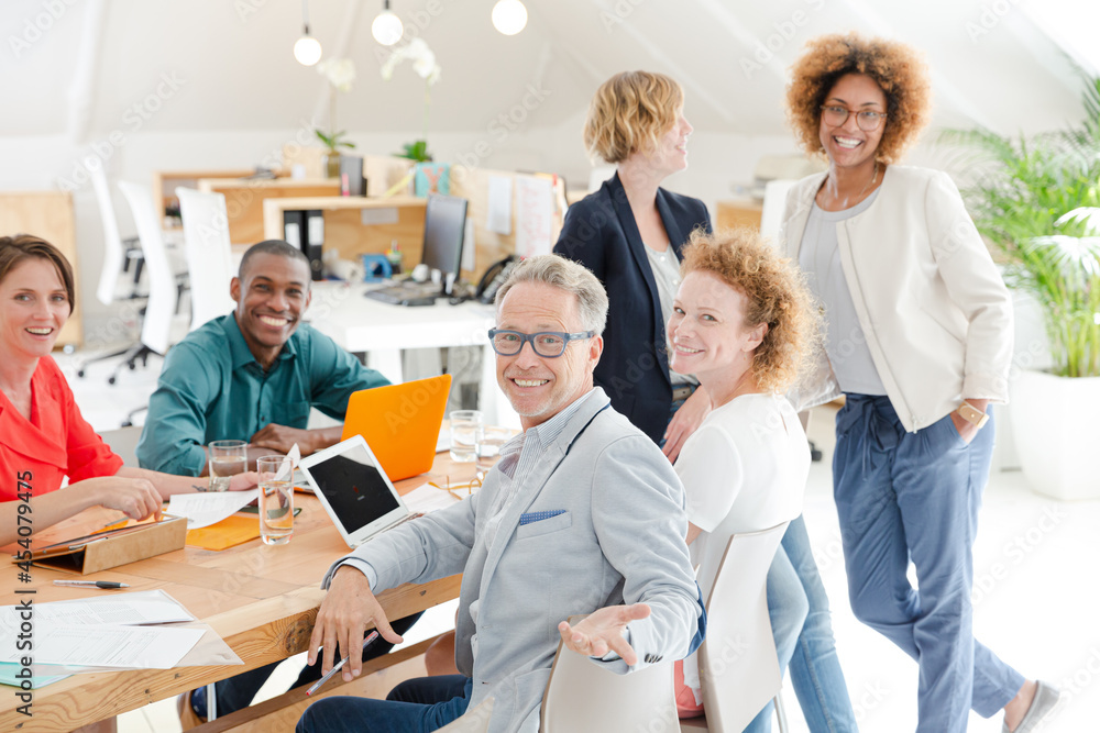 Fototapeta premium Office workers talking and smiling at meeting