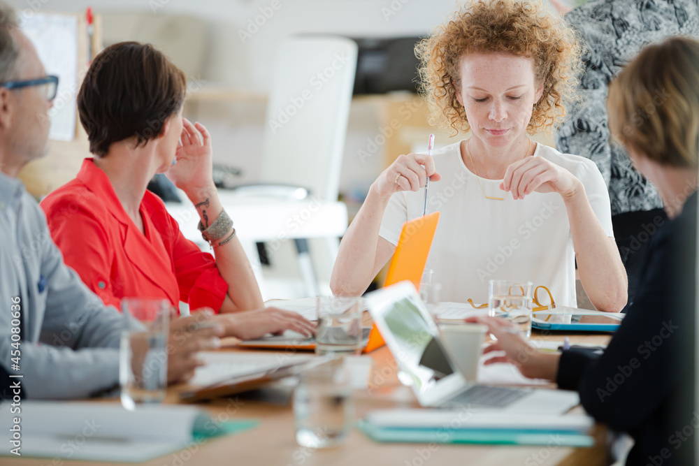 Fototapeta premium Office workers talking at desk