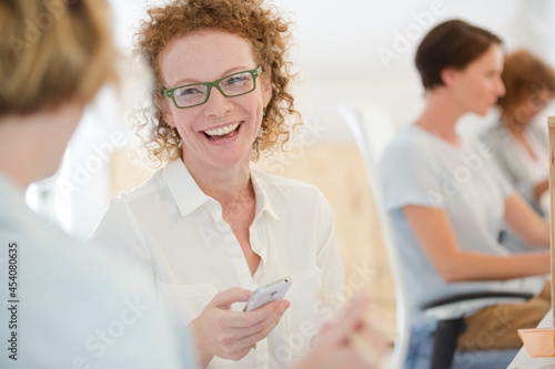 Portrait of woman using smart phone and smiling