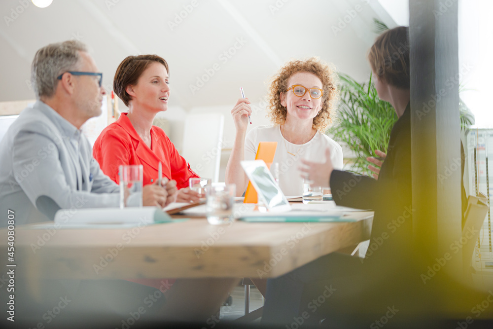 Office workers talking at desk