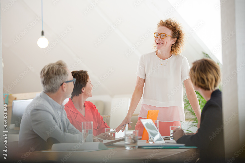 Office workers talking at desk Office workers talking at desk
