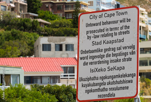 sign or signage outdoors for public awareness on behaviour in Cape Town in three official languages, English, Afrikaans and Xhosa