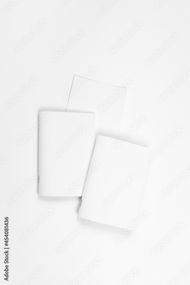 Mock up of notebook. Blank sheets of paper for brochure or notebook on white isolated background, top view. Mock up of notebook. Blank sheets of paper for brochure or notebook on white isolated background, top view.