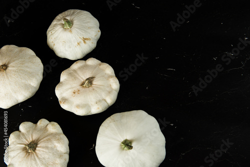 patison pumpkin squashed on dark kitchen table, whole bio raw vegetable brom village gardening