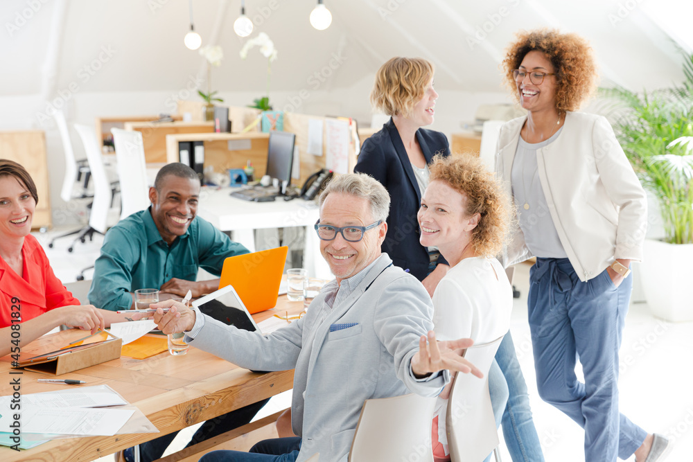 Fototapeta premium Office workers talking and smiling at meeting