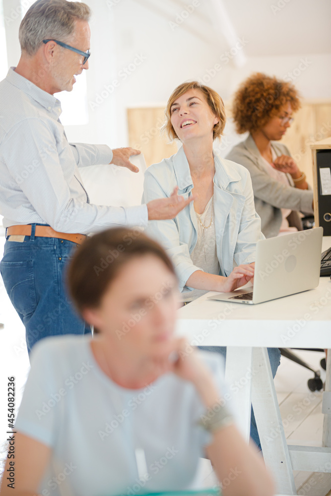 Fototapeta premium Office workers talking at desk