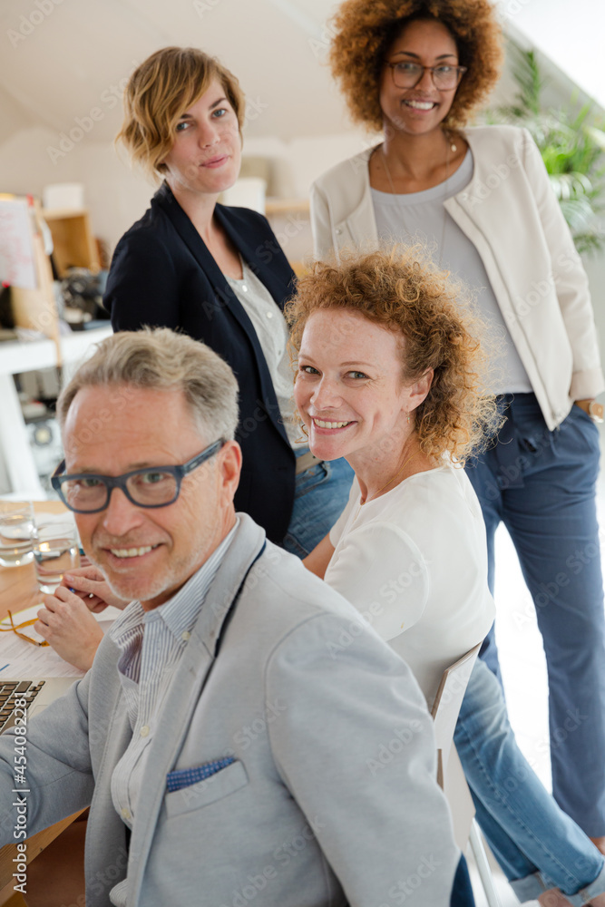 Fototapeta premium Office workers talking and smiling at meeting
