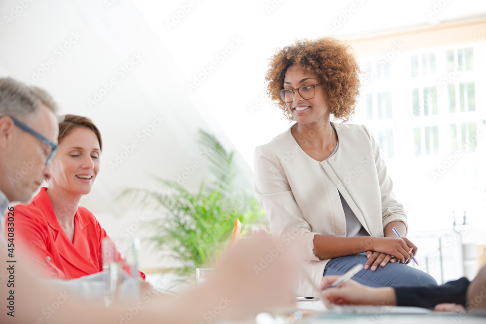 Office workers talking at desk Office workers talking at desk