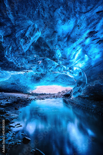 Glacial river flows through a blue ice cave. Part of the Vatnajokull glacier in southeast Iceland