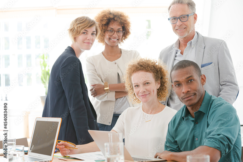 Portrait of office team smiling in conference room Portrait of office team smiling in conference room