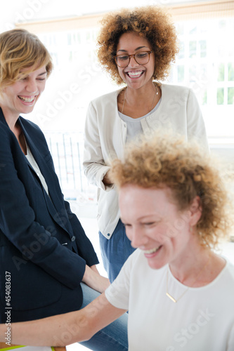 Women talking and smiling in office