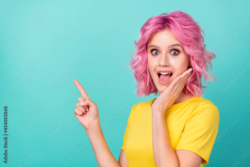 Photo of young funny pink hairdo lady point empty space wear yellow t-shirt isolated on teal color background Photo of young funny pink hairdo lady point empty space wear yellow t-shirt isolated on teal color background