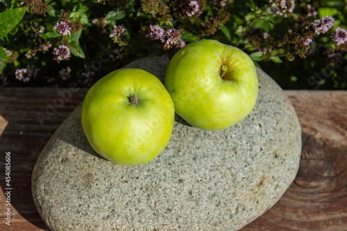 Fresh green apples in the bucket. On rustic stone background. Free space for text . Top view