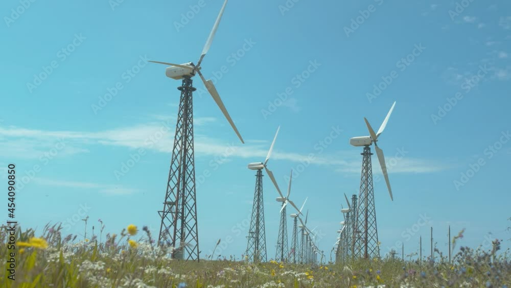 Wind mill, clouds and blue sky. Wind power turbines generating renewable clean energy. Wind mill, clouds and blue sky. Wind power turbines generating renewable clean energy.