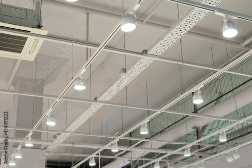 Bild auf Leinwand Ceiling with bright lights in a modern warehouse, shopping center building, office or other commercial real estate object