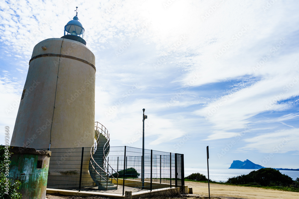 Obraz premium Lighthouse and Gibraltar rock, La Alcaidesa, Spain.