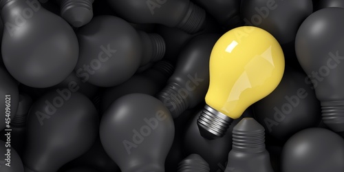 A good idea among bad ideas. One yellow lightbulb over several black lightbulbs.  photo