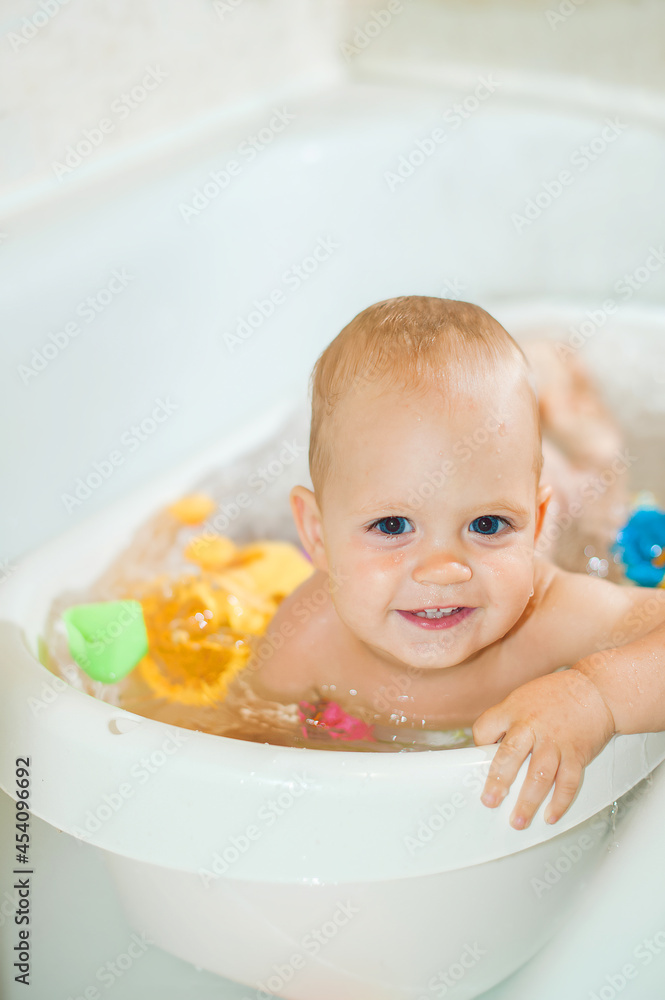Happy toddler boy playing in bathroom close-up and copy space. Bathing babies concept... Happy toddler boy playing in bathroom close-up and copy space. Bathing babies concept...