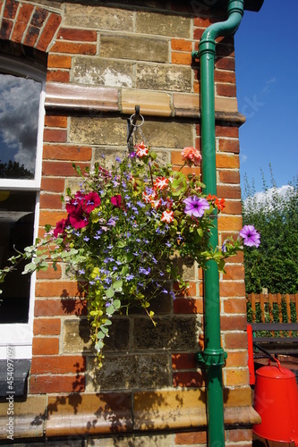 Flowers in a hanging basket at old train station in  Colne Valley Railway