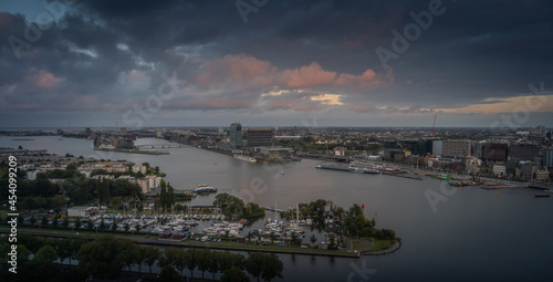 Aerial view of the city of Amsterdam, capital of the Netherlands on a calm summer evening, during cloudy sunset © Lorant