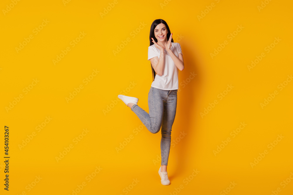 Full body photo of cool attractive girl happy positive smile wear casual outfit excited isolated yellow color background Full body photo of cool attractive girl happy positive smile wear casual outfit excited isolated yellow color background