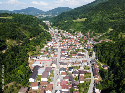 A small town in a valley between hills. Aerial drone view Kresevo, Bosnia and Herzegovina. Buildings, streets and residential houses. A view from above on the roof of the houses in town Kreševo.  